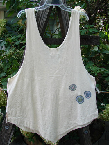 2001 Katy Vest Chain Rain Natural Size 1, featuring patches, lengthy thinner shoulder straps, a wider rounded A-line shape, swingy weighted lower, tiny vented sides, two triangular pockets, and varying hemline.