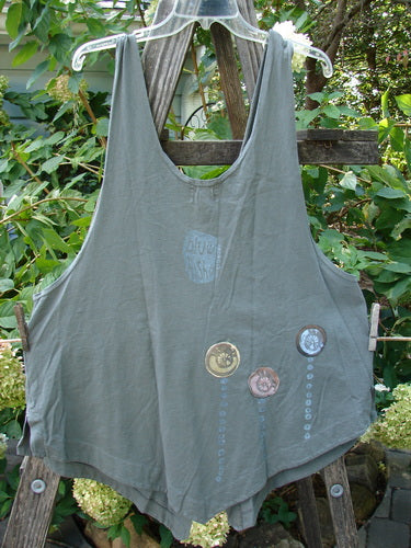 2001 Katy Vest Shell Rain Inkpod Size 1, featuring lengthy thinner shoulder straps, a wider rounded A-line shape, two blue fish button closures, and front triangular pockets in organic cotton.