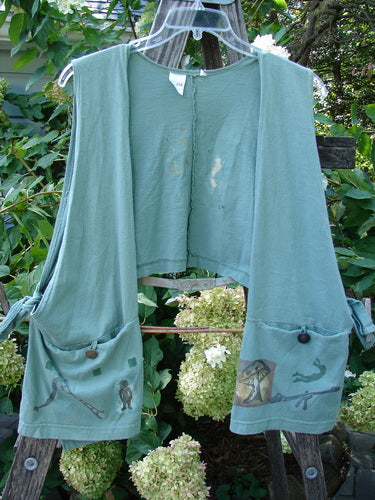 1994 Pocket Vest Magic Dance Kelp OSFA displayed on a rack, featuring two bottom pockets with vintage button closures and side ties for adjustable fit.