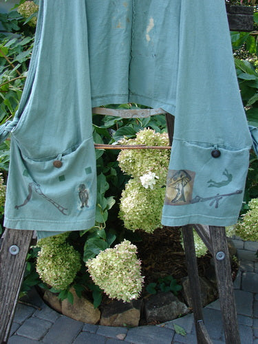 1994 Pocket Vest Magic Dance Kelp OSFA displayed on a ladder, featuring two bottom pockets with vintage buttons and loop closures, tie-in sides, and a cropped back line.