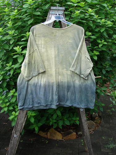 Barclay Wide Line Tee Primitive Circle Path Mottled Olive Grey OSFA displayed on a hanger, showcasing its seamless, boxy design with a rounded neckline and significant drop shoulders, embodying BlueFishFinder's unique vintage style.