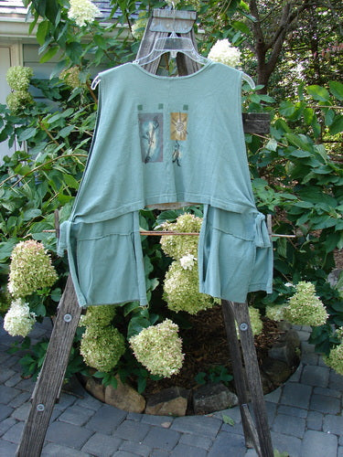 1994 Pocket Vest Magic Dance Kelp OSFA on a rack, featuring drop front, two bottom pockets with vintage buttons, tie sides for adjustable fit, and a cropped back line.