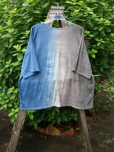 Barclay Wide Line Tee Wind Fish Mottled Navy Gray OSFA displayed on a wooden stand, showcasing its seamless, boxy shape with drop shoulders and a slightly ribbed neckline.