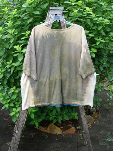 Barclay NWT Center Seam Wide Line Tee Earth & Sea Mottled Lens OSFA featuring a wide boxy shape, rounded ribbed neckline, drop shoulders, and vertical center seam, showcased outdoors.