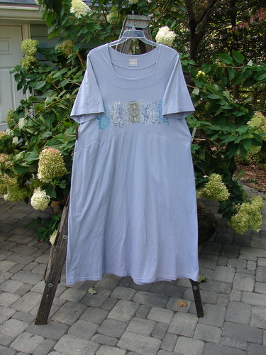 1999 Windmill Dress Turn Wind Lilac Size 2 displayed on a hanger with a sweeping A-line shape, squared neckline, downward yoke waist, and flared hemline, showcasing graceful movement and deep side pockets.