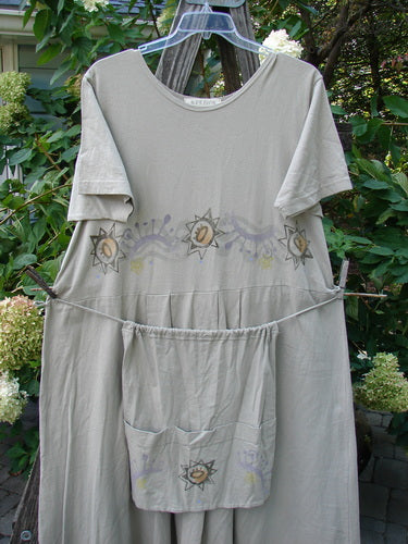 1997 Lawn Dress Star Path Wheat Size 2 featuring a pocketed detachable apron, tailored pleats, drop waistline, and a unique star path theme paint. Made from organic cotton, perfect condition.