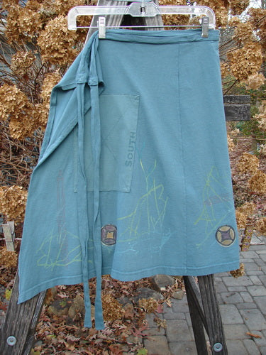 2000 NWT Grid Patch Wrap Skirt in Puddle. Organic cotton skirt with long belt, directional paint, cross-stitched accents, and a huge painted patch. Versatile as a mini skirt or over straight bottoms. Length: 27" (long) or 23" (short), width: 56".
