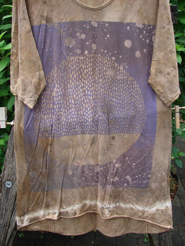 Barclay Tournesol Slim Tunic Moon Rise Mottled Earth OSFA with drop shoulders, three-quarter loose sleeves, and a rounded neckline, showcased on a pole, highlighting its unique longer back hemline design.