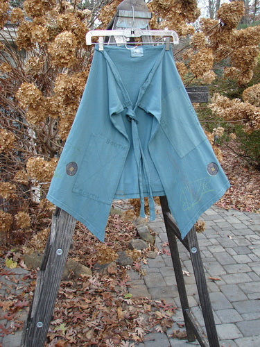 2000 NWT Grid Patch Wrap Skirt in Puddle, OSFA, on clothes rack. Blue robe with long belt, cross-stitched accents, and painted patch.