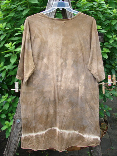 Barclay Tournesol Slim Tunic Moon Rise Mottled Earth OSFA displayed outdoors on a clothesline, showcasing its longer tunic length, drop shoulders, and loose three-quarter sleeves, embodying Bluefishfinder.com's vintage style.