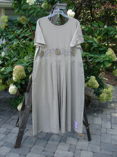 1997 Lawn Dress Star Path Wheat Size 2 displayed on a wooden ladder, featuring tailored pleats, a detachable apron with pockets, and signature Blue Fish Patch.