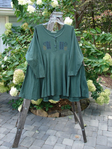 1994 Juniper Dress Forest Path Deep Moss Size 2 displayed on a rack, showcasing its wide rounded collar, sectional panels, and full sweeping swing lower hem.