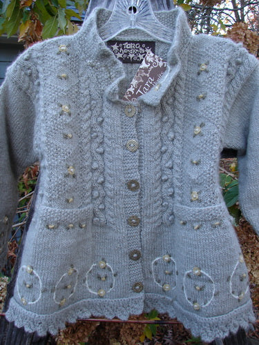 Tara Handknits NWT Kids Wild Smock Sweater Jacket Size Medium, featuring intricate knit patterns, oversized metal buttons, lace collar, and floral accents, embodying artisanal craftsmanship from Bluefishfinder's vintage collection.