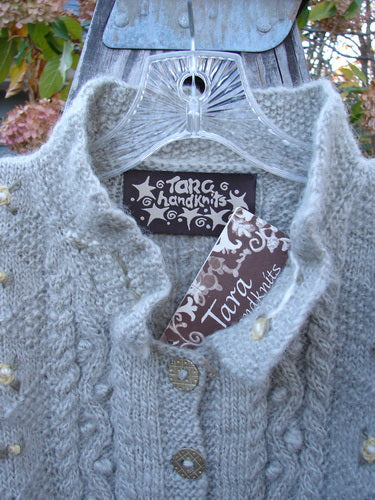 Tara Handknits NWT Kids Wild Smock Sweater Jacket Size Medium, showcasing intricate knit patterns, lace collar, oversized buttons, and front pockets, crafted by Hot Knots Sisters, perfect for winter wear.