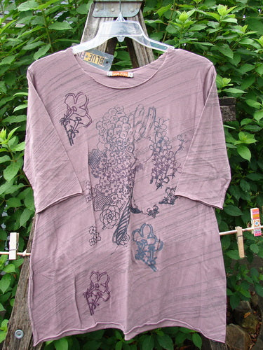Barclay NWT Viscose Horizon Raw Cut Tee in Floral Cluster Tulsi Rose Striation, featuring a raw cut neckline, three-quarter sleeves, and a slight A-line shape with unique floral and feather patterns.
