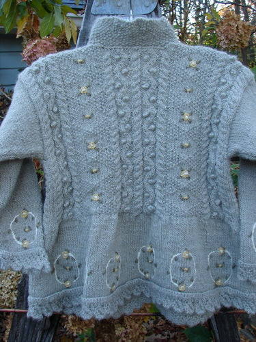 Tara Handknits NWT Kids Wild Smock Sweater Jacket Size Medium features gold buttons, intricate knit patterns, and a lace collar, embodying the handcrafted charm of Bluefishfinder's unique vintage style.