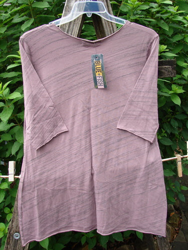 Barclay NWT Viscose Horizon Raw Cut Tee in Floral Cluster Tulsi Rose Striation, displayed on a rack, highlights a raw cut neckline and three-quarter sleeves, embodying Bluefishfinder.com's vintage, expressive style.