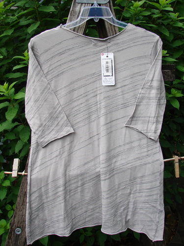 Barclay NWT Viscose Horizon Raw Cut Tee Wheat Field Vintage Quartz Striation Size 1 displayed on a clothes hanger, featuring a raw cut neckline and three-quarter length sleeves.