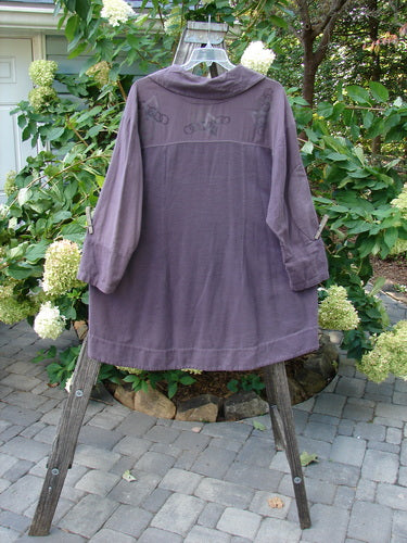 2000 Flannel Fanne Shirt Bubbles Eggplant Size 2 displayed on a wooden stand, showcasing its deep V-neck, contrasting flannel and canvas patterning, and unique hook and eye closures.