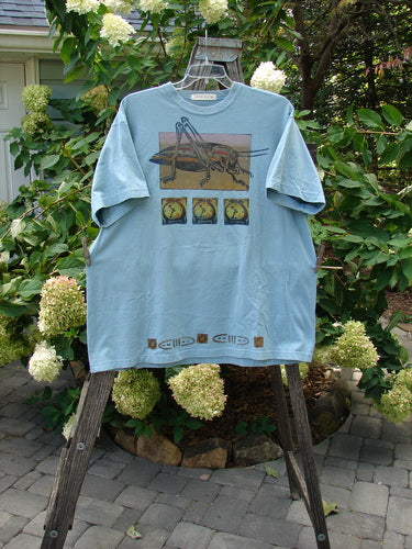 1994 Short Sleeved Tee Cricket Time Ice Size 2 XL on a swinger, showcasing its square box shape, drop shoulders, and thicker ribbed neckline, with an artistic cricket-themed design.