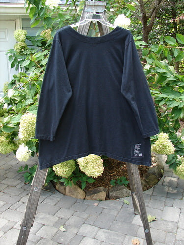 1998 Pocket Top Lace Up Celtic Infinity Black Size 1 on a clothes rack, showcasing unique A-line shape, extra-long neckline, and oversized painted pocket.