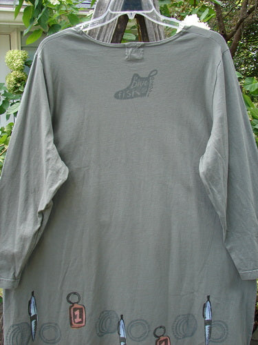 2001 Market Top Junk Drawer Inkpod Size 2, featuring a grey shirt with a logo, displayed on a hanger. The shirt has a unique A-line shape, drop shoulders, and bright Junk Drawer themed paint.