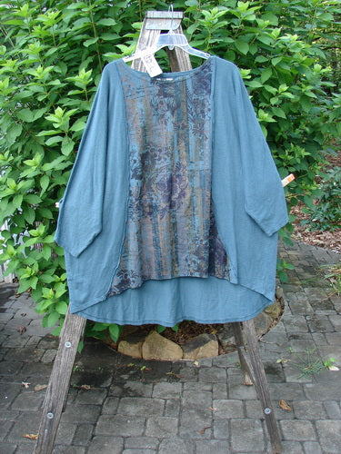 Barclay NWT Cotton Hemp Exterior Stitch Hi Low Tunic Botanical Hypnea Teal OSFA displayed on a hanger, showcasing its dolman sleeves, rounded neckline, and curvy seams, embodying Bluefishfinder.com's unique vintage style.