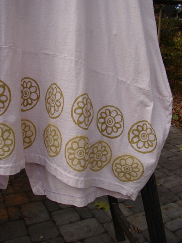 Barclay Shell Button Drop Pocket Vest in Pink Tile, featuring a white towel with green circles, gold designs, and a white towel on a chair.