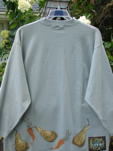 1998 Heavy Crossover V-Neck Bountiful Harvest Birdsong Size 2 shirt featuring a detailed vegetable drawing on the front, long sleeves, and a ribbed V-shaped neckline.