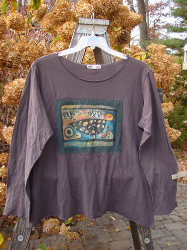 Barclay PMU Patched Batiste Long Sleeved Tee on a swinger, featuring a Love Dove theme center patch. Size 2.