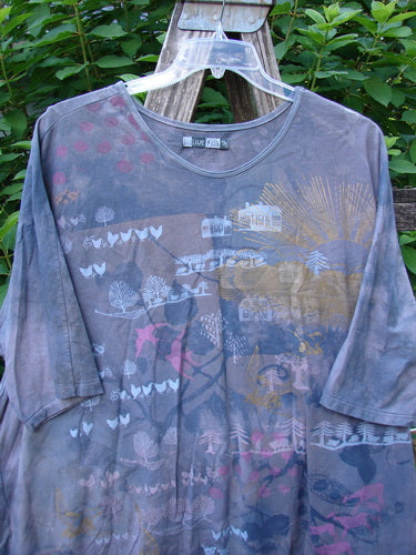 Barclay Tournesol Tunic Farm Land Mottled Grey Sky OSFA displayed on a hanger, showcasing its mid-length design, drop shoulders, loose three-quarter sleeves, and unique varying hemline with a painted farm land theme.