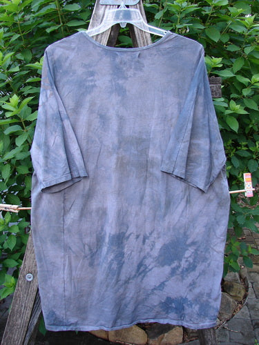 Barclay Tournesol Tunic in Mottled Grey Sky, featuring drop shoulders, loose three-quarter sleeves, and a rounded neckline, elegantly displayed on a clothesline, embodying Bluefishfinder.com's creative vintage essence.