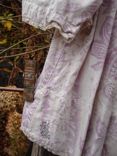 Magnolia Pearl Homespun Linen Crochet Bunny Blouse Swirl Lavender OSFA, showcasing a crochet squared neckline with tie, three-quarter sleeves, and a lace-edged hem, captured in a close-up emphasizing fabric texture.