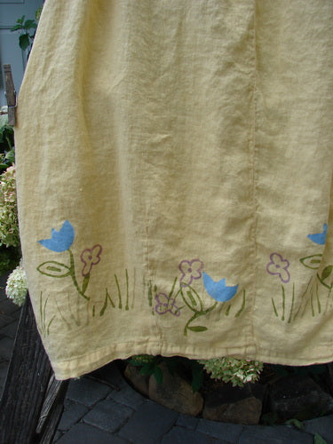 Close-up of the 1999 Windy Day Skirt Tulip Buttercup Size 2, showcasing a full elastic waistline, reverse bell shape with vertical pleats, and hand-painted spring tulip pattern on lightweight linen.