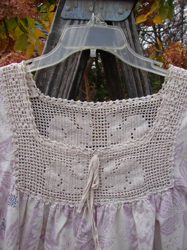 Magnolia Pearl Homespun Linen Crochet Bunny Blouse Swirl Lavender OSFA, featuring a crochet square neckline, three-quarter sleeves, lace details, and a front pocket with bunny motif.