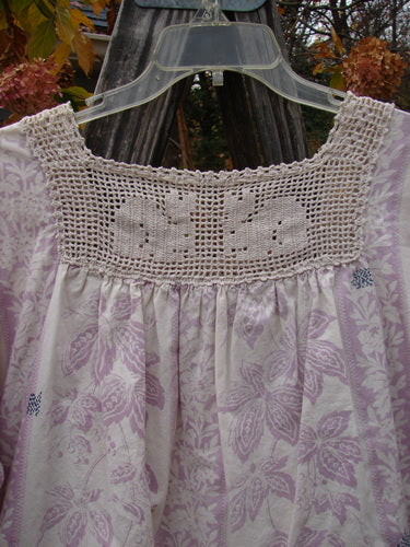 Magnolia Pearl Homespun Linen Crochet Bunny Blouse Swirl Lavender OSFA featuring a crochet squared neckline with a tie, three-quarter sleeves, and a widening flair, highlighting intricate hand stitchery and distressing.