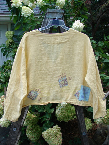 1999 Weathervane Jacket Crown Buttercup Size 2: Yellow linen jacket with unique front mix-match buttons, top porcelain button, inward rounded side hem, deep V neckline, and summer tulip theme paint.