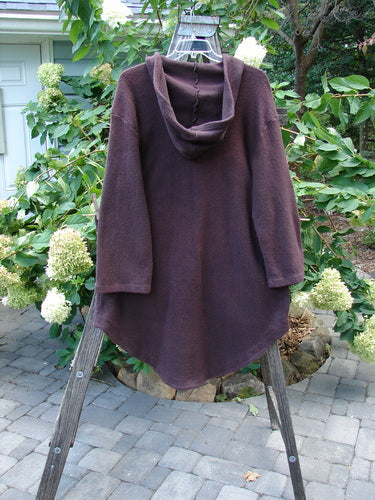 Barclay Celtic Moss Hooded 2 Pocket Jacket Unpainted Brum Size 0 displayed on a wooden rack, showcasing its cozy hoodie, oversized buttons, and two front pockets.