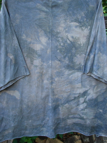 Barclay Raw Edge Flutter Collar High Low Top features a unique rounded batiste flutter neckline, short raw edge dolman sleeves, and a wide boxy shape, embodying BlueFishFinder's vintage style.