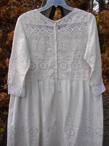 Magnolia Pearl European Cotton Eyelet Lucienne Dress Antique White OSFA: A white dress with eyelet and lace fabric, rounded lacey neckline, and full skirt.