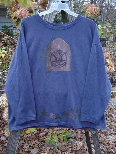 1993 Long Sleeved Tee Center Lotus Flower Medallion Indigo OSFA displayed on a wooden pole, featuring a unique lotus flower medallion design and a soft rib neckline, from Bluefishfinder.com's vintage collection.