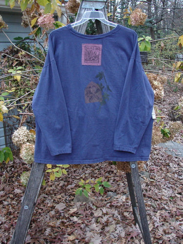 1993 Long Sleeved Tee Center Lotus Flower Medallion Indigo OSFA displayed on a clothes rack, highlighting its unique boxier shape and lotus flower medallion design from Bluefishfinder.com's vintage collection.