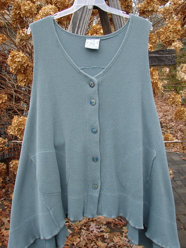 1992 Thermal Tunic Vest on clothes rack with blue buttons