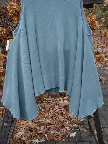 1992 Thermal Tunic Vest on rack with blue sweater, pockets, and dippy hemline