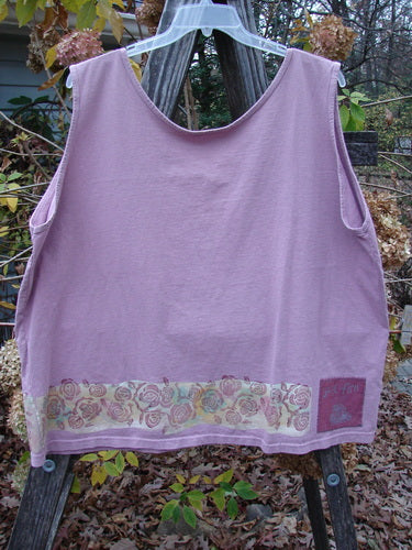 1992 Oversized Tank Continuous Rose Amethyst OSFA displayed on a wooden pole, highlighting its wide boxy shape and deep arm openings, with signature Blue Fish patch on the lower back.