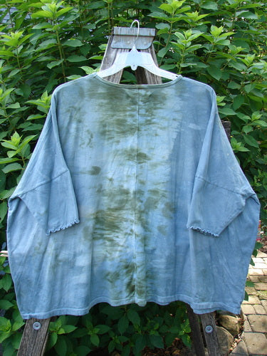 Barclay Dolman Curl Edge Square Pullover Night Star Mottled Moss OSFA displayed outdoors, showcasing its seamless boxy shape, rounded neckline, and unique curly arm edgings, embodying the BlueFishFinder's creative vintage style.