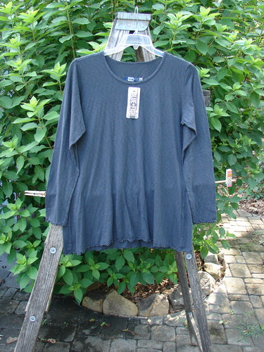Barclay NWT Modal Batiste Layer Top Unpainted Shadow Size 1 is displayed on a swinger. Features visible include long, slightly narrow sleeves, A-line shape, hip flare, and raw edges.