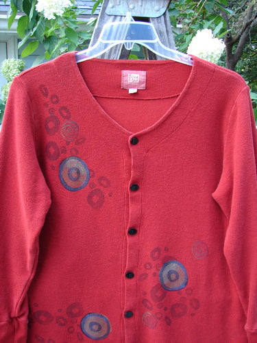 2000 Thermal Lu Top Pinwheel Bittersweet Size 2: A red sweater with blue circles, ribbed cuffs, rubberized buttons, and a slightly A-line shape, from Bluefishfinder's Winter 2000 Collection.