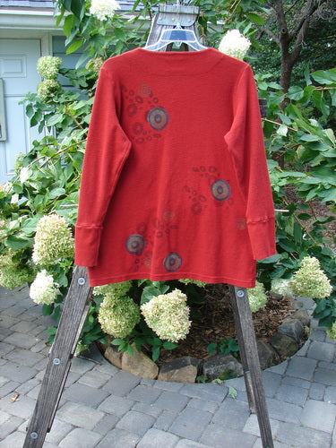 2000 Thermal Lu Top Pinwheel Bittersweet Size 2 displayed on a hanger, showcasing its ribbed texture, rubberized buttons, and slight A-line shape.