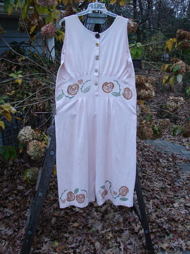 1992 Pant Overall Jumper Rose Sea Shell OSFA displayed on a rack, showcasing its vintage design with embroidered roses, swingy lowers, and distinctive button detailing from Blue Fish Clothing's Summer Collection.